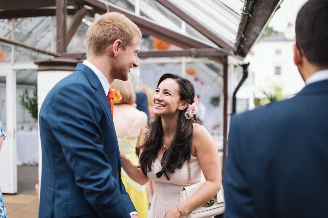 the groom shares a joke with wedding guests