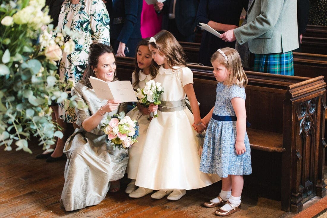 maid of honour and flower girls singing the hymns 