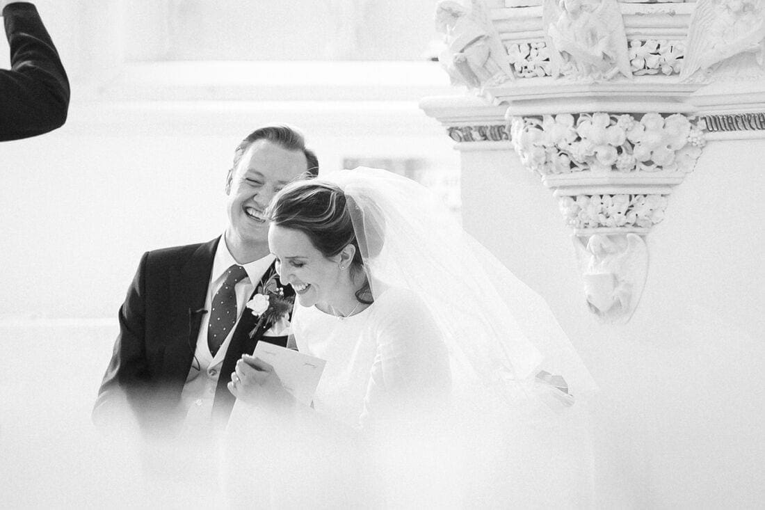 husband and wife enjoy a joke with the vicar