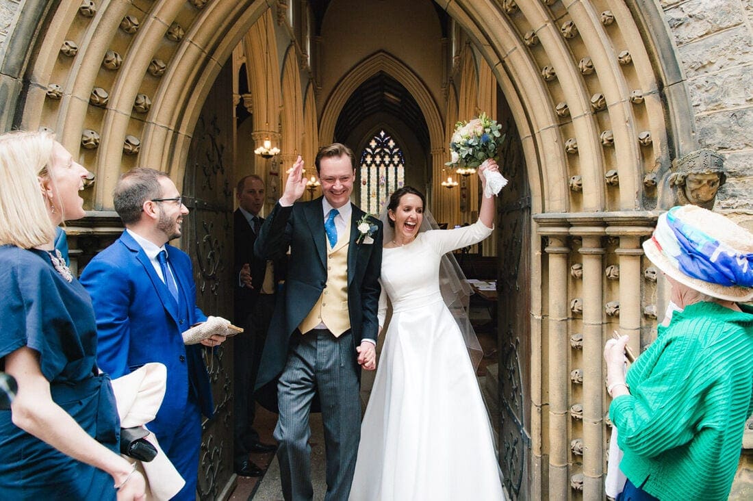 the bride and groom leaving church