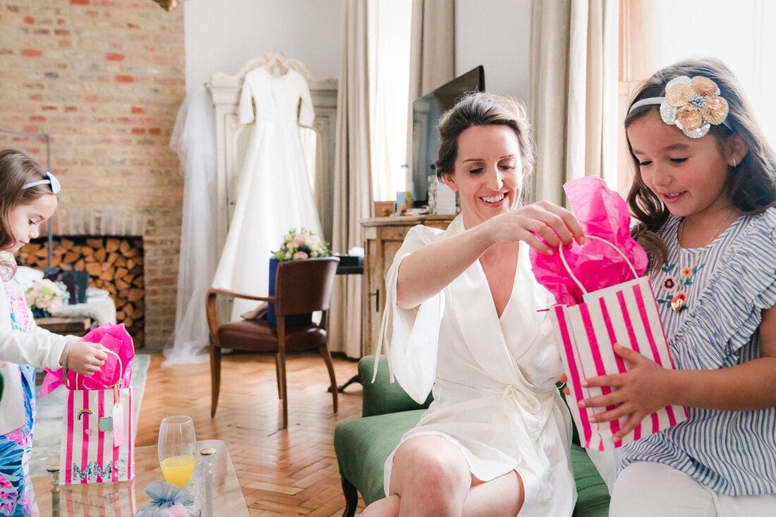 bride gives gifts to the two flower girls